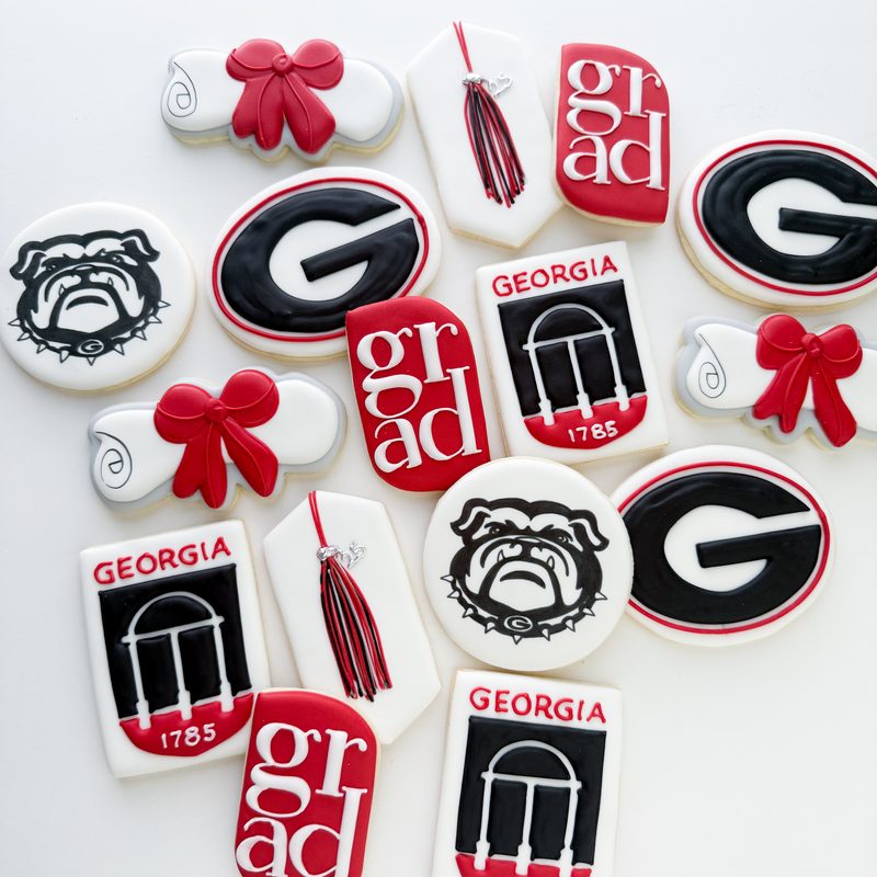 A Georgia graduation set in red and black: grad caps, tassels, bulldogs and lettered rounds.