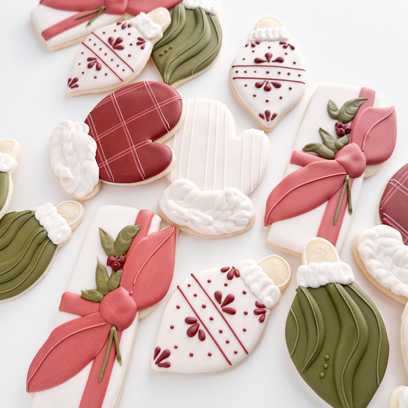A Christmas set in cranberry and pine: plaid and striped mittens, ribboned presents, ornaments and trees.